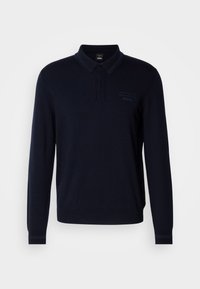 Polo noir à manches longues avec col boutonné et logo discret "Porsche BOSS" sur la poitrine gauche.