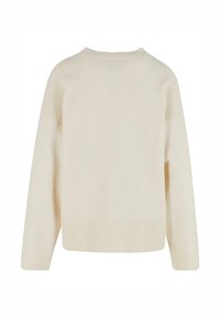 Cream-colored knitted sweater with a ribbed hem, round neckline, and dropped shoulders, featuring a soft texture and relaxed fit.