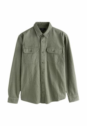 Olíva z öld, hosszú ujjú, gombos ing texturált anyagból, két mellkasi zsebbel és klasszikus gallérral.