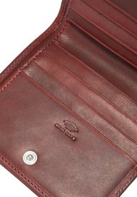 Red leather wallet interior featuring multiple card slots, RFID protection imprint, and contrasting stitching detail for added texture.