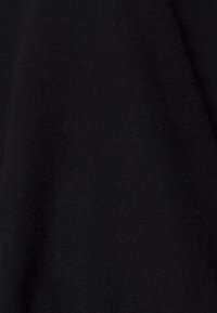 Black knit fabric, textured surface with a soft, smooth finish. Uniform color without patterns or accents. Suitable for garments or accessories.
