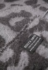 Gray sweater featuring a soft, textured fabric with a leopard print pattern. Includes a stitched label reading "SOCCX ORIG. LIMITED EDITION."