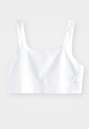 Weißes geripptes Bralette mit breiten Schulterträgern, nahtlosem Design und einem weichen elastischen Bund am unteren Ende für einen sicheren Sitz.