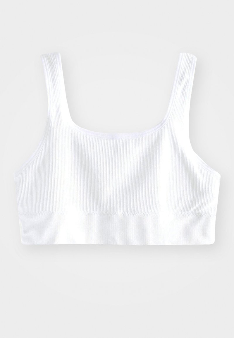 Biała ribbed bralettka z szerokimi ramiączkami, bezszwowym wzornictwem oraz miękkim elastycznym paskiem na dole, zapewniającym pewne dopasowanie.