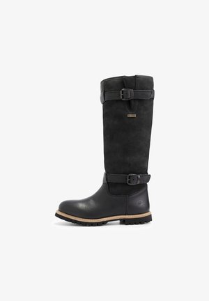 Botte en cuir noir mi-mollet avec deux sangles réglables et boucles, semelle robuste, et petite plaque métallique de marque sur la partie supérieure de la tige.