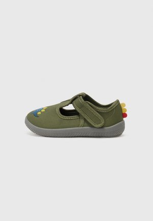 Green fabric shoe with a Velcro strap, featuring a blue dinosaur design, yellow and red accents, and a flexible grey rubber sole.