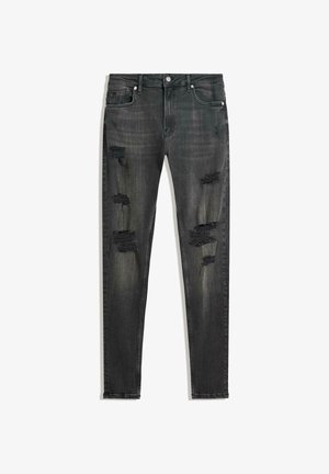 Jeans neri slim-fit in denim, con dettagli strappati sul davanti e una texture sbiadita. Design standard a cinque tasche con accessori in metallo.