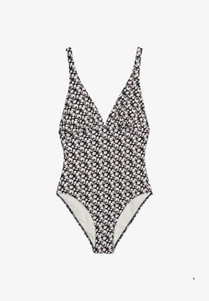 Costume intero con scollo a V profondo e spalline sottili, caratterizzato da un motivo floreale bianco e nero.