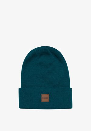 Küüpne sinine kindel beanie, millel on volditud äär ja ruudukujuline pruun silt, millel on kiri "URBAN CLASSICS". Pehme tekstuur ja istuv disain.