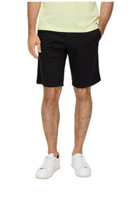 Black shorts with a straight cut, featuring side pockets and a smooth texture, paired with white sneakers.