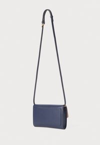 Navy leather crossbody bag with adjustable strap, rectangular shape, smooth texture, and a front pocket. Features minimalist design and gold hardware.