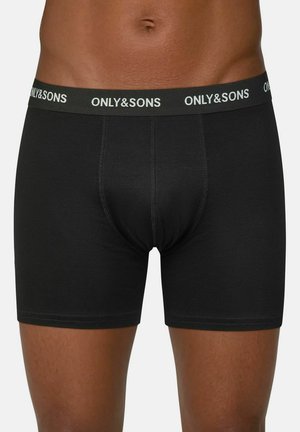 Black cotton boxer shorts with a logo-emblazoned elastic waistband. Features a fitted design and stitching detail along the seams.