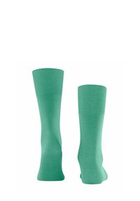 Grüne knielange Socken mit gerippten Bündchen, aus glattem Stoff gefertigt. Sie verfügen über ein nahtloses Design und eine gleichmäßige Farbgebung.