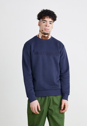 Navyblauwe sweatshirt met ronde halslijn en geribde boorden, met een reliëf "Timberland" logo op de borst.