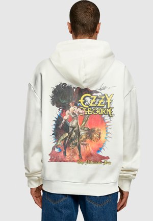 Hvit hettegenser med et fargerikt grafisk design på baksiden, som viser en figur med svart hår og et demonisk vesen, med teksten "Ozzy Osbourne".