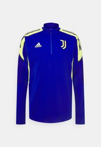 Blaue Sportjacke mit einem Viertel-Reißverschluss, die gelbe Akzente an den Schultern, langen Ärmeln und ein Juventus-Logo auf der Brust aufweist.