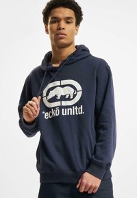Navy hoodie featuring a white graphic of a rhino and logo on the front, with a kangaroo pocket and adjustable drawstring hood.