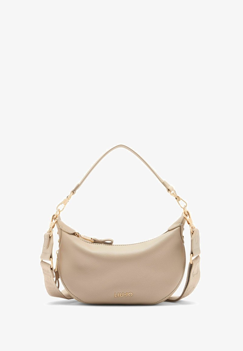 Beige leather handbag with a curved shape, gold hardware accents, and an adjustable strap featuring a patterned texture. Brand name displayed.