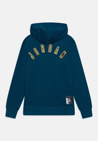 Morska zielona bluza z kapturem z zaokrąglonym żółtym napisem "JORDAN" na plecach, z metką z logo u dołu po prawej stronie. Miękka, gładka faktura.
