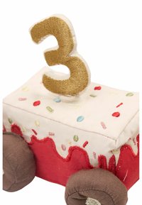 Vehicul de jucărie cu un design moale, brodat. Caroseria de culoare crem prezintă stropi colorati, detalii din glazură roșie și un „3” auriu în vârf.