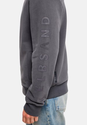 Gray sweatshirt with a textured finish, featuring a side logo in matching color, ribbed cuffs, and a relaxed fit.