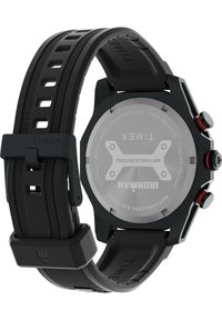 Black waterproof Timex watch with a textured silicone strap, octagonal case, stainless steel back, and red accents on the crown and buttons.