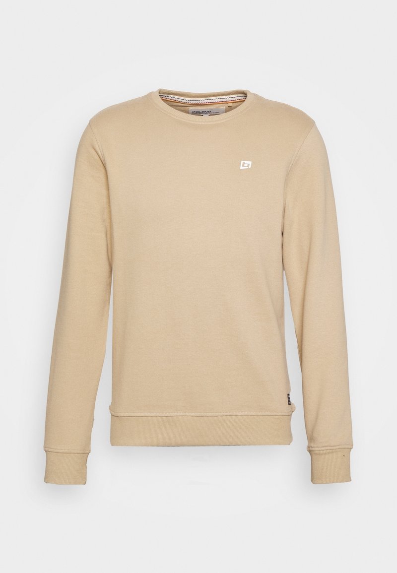 Sweat-shirt beige à manches longues avec col rond, poignets et ourlet côtelés, avec un petit logo blanc sur la poitrine gauche.