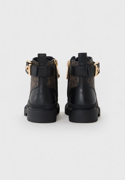 Black leather ankle boots with a patterned textile panel, gold hardware accents, side zippers, and sturdy rubber soles.