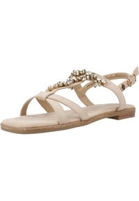 Sandalias planas beige con múltiples correas, adornos de joyas en la parte superior, una plantilla de tacto suave y un tacón bajo y plano.