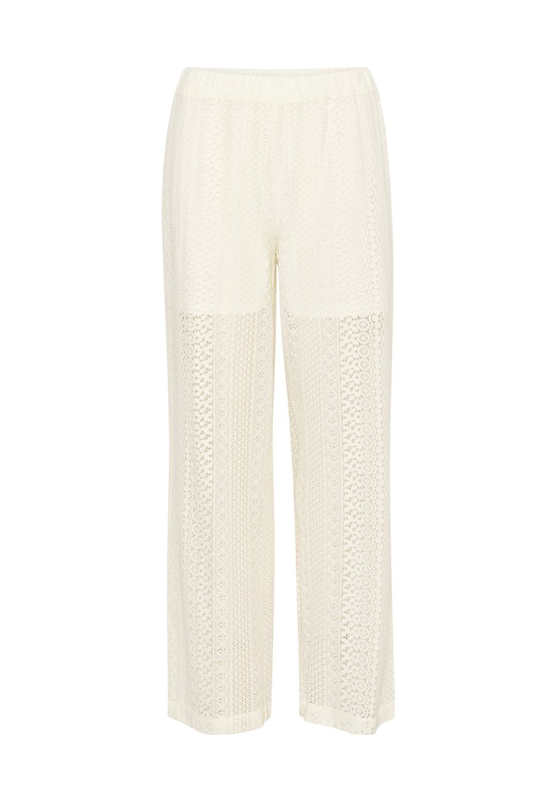 Pantalon large couleur crème avec un design texturé et à motifs, taille élastique et accents en patchwork. Tissu léger et respirant.