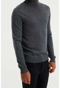 Grey turtleneck sweater crafted from a soft, knitted material. Features long sleeves, ribbed cuffs, and a relaxed fit.