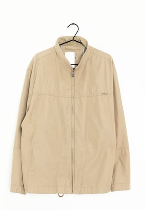 Tan lightweight jacket with a standing collar, front zipper, and two side pockets. Features smooth texture and simple stitching details.