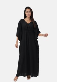 Robe maxi noire avec des manches larges, détail froncé à la taille et décolleté en V, fabriquée en tissu léger et fluide.