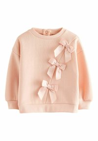 Sudadera rosa claro hecha de tela suave, con tres lazos de satén en el frente y puños y dobladillo acanalados. Cierre trasero con botones.