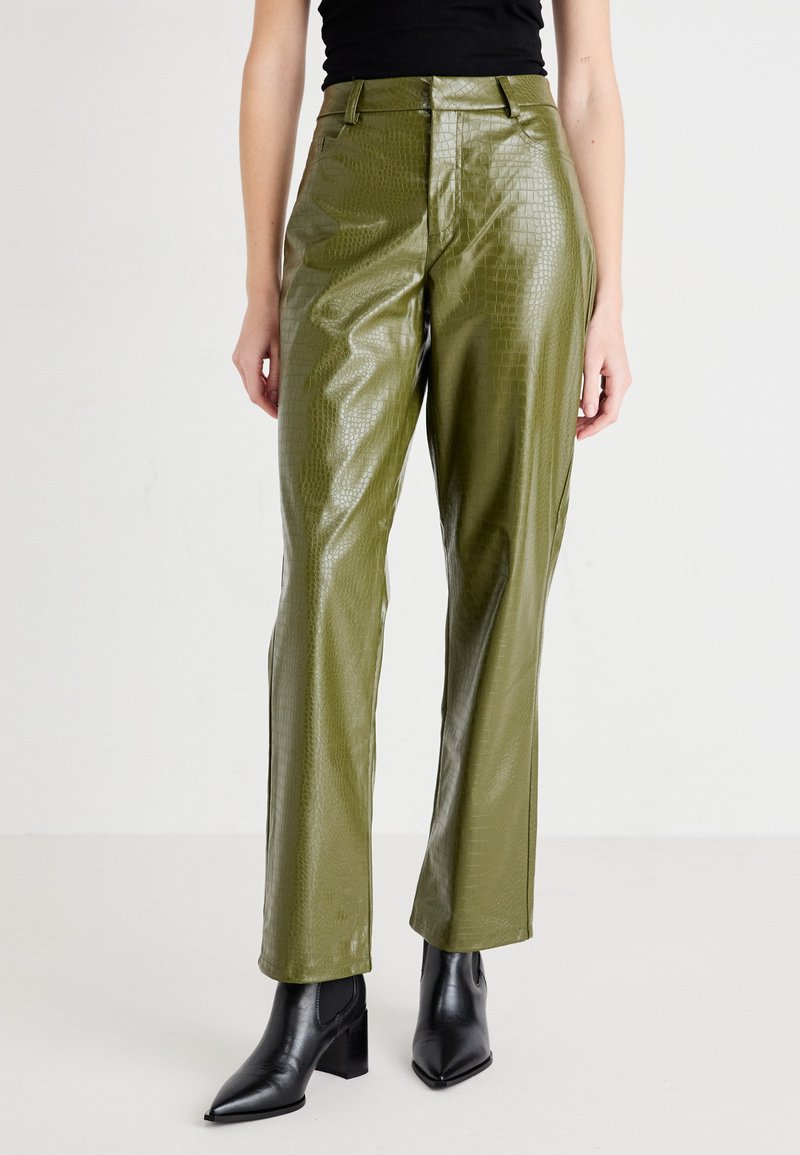 Green faux leather trousers with a crocodile skin texture, straight-leg design, and mid-rise waist, paired with black heeled ankle boots.