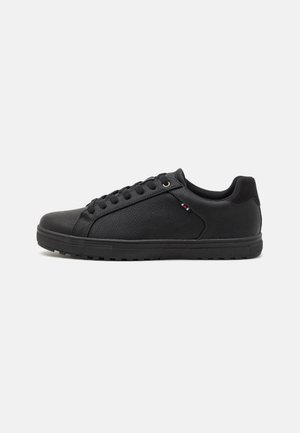 Black sneakers with a smooth leather texture, rounded toe, contrast stitching, and rubber sole. Features minimalistic design and lace closure.