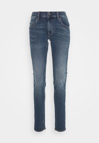 Slim fit jeans i mörkblå denim med knappstängning, femfickorsdesign, lätt färgning på låren och sydd nederkant.