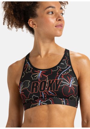 Reggiseno sportivo nero con motivi floreali in rosso e blu, con la scritta "ROXY" stampata in lettere grasse. Realizzato in materiale elasticizzato e traspirante.