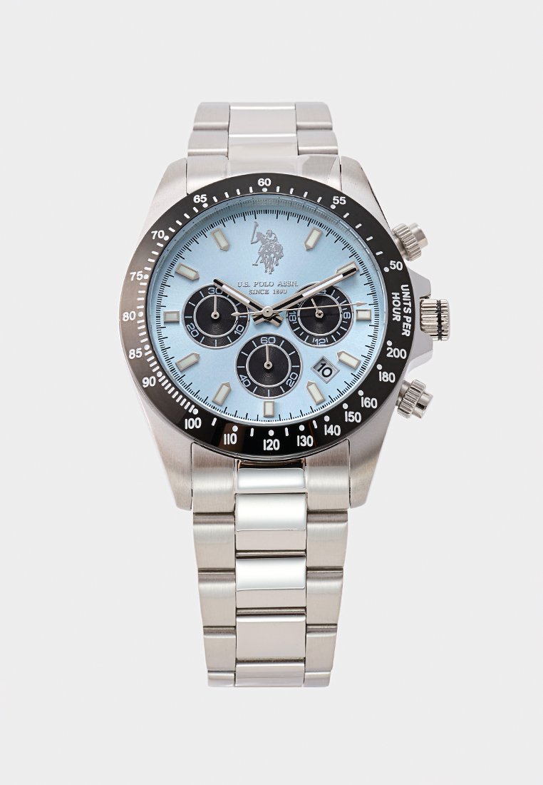 Montre en acier inoxydable avec un cadran bleu clair, une lunette noire, trois sous-cadrans et des accents argentés. Comprend un bracelet en maillons métalliques et un affichage de la date.