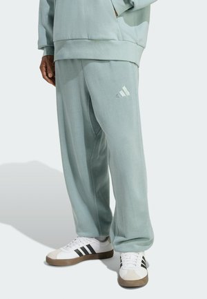 Lichtgroene, relaxte sweatpants met een elastische tailleband en zijzakken; voorzien van een subtiele, witte logo-detail met drie strepen.