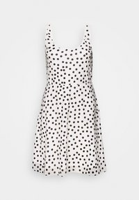 Valkoinen hihaton mekko, jossa on muotoiltu yläosa ja levenevä hame, ja jonka pinnassa on musta pilkku-kuvio. Valmistettu sileästä kankaasta.