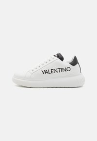 White leather sneaker with a black heel cap, featuring a prominent VALENTINO logo in black on the side and a thick white sole.