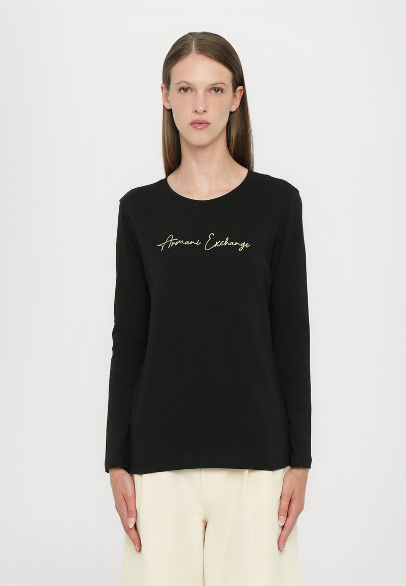Black long-sleeve T-shirt made of cotton with a round neckline. Features gold "Armani Exchange" script across the chest. Simple and fitted design.