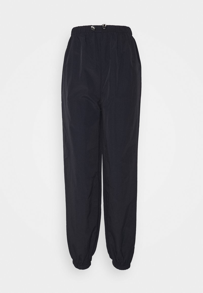 Black, lightweight, stretchable pants with an elastic waistband and cuffs, featuring a sleek, smooth texture and a relaxed fit.