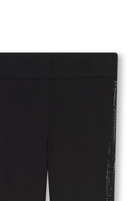 Leggings noirs avec une texture lisse et une taille élastique, présentant une bande verticale de petits accents brillants sur le côté.