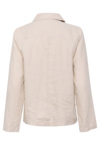 Beige langærmet linnedjakke med en lige krave, synlig bagå seam-stikning og en afslappet pasform.