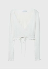 Valkoinen ribbed wrap -paita, jossa on pitkät hihat, syvä V-kaula-aukko ja vyötärölle solmittava nauha. Paita päättyy repsottavaan helmaan.