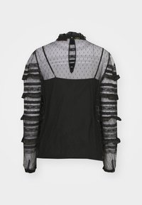 Blusa nera con tessuto trasparente a pois. Maniche arricciate e dettaglio sulla schiena, con un'apertura a oblò sul collo. Sovrapposizioni strutturate e righe.