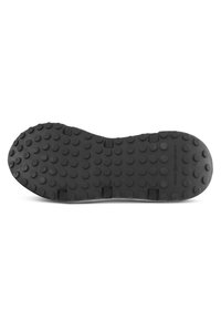 Svart gummisula med en texturerad yta, med runda gropar för grepp och spår för flexibilitet. Accenter inkluderar tillverkarens varumärke.