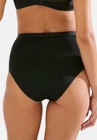 Hoge taille zwarte slip van een gladde, rekbare stof, met een naadloos ontwerp en een comfortabele tailleband, geschikt voor sportieve kleding.